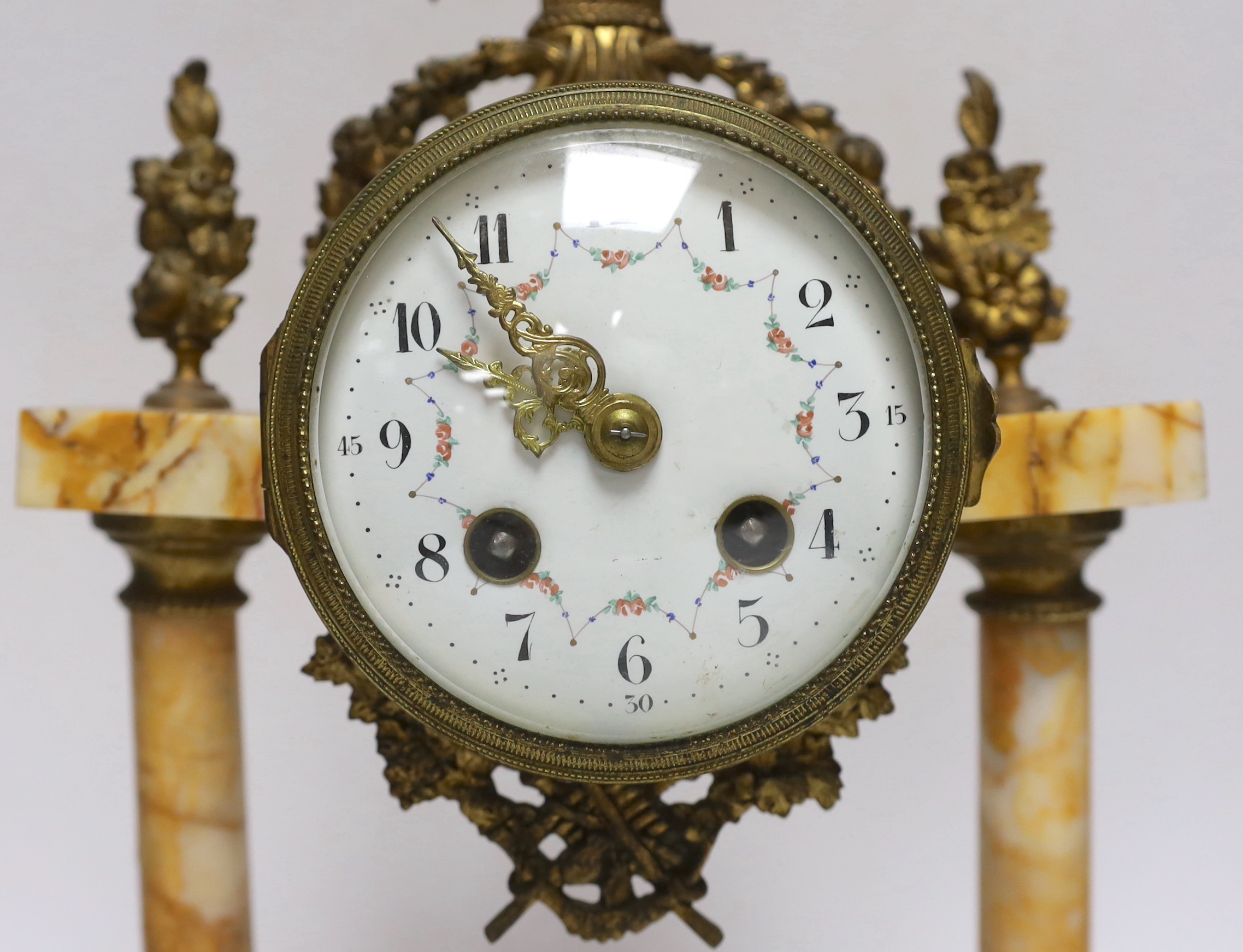 A late 19th century French gilt metal and variegated marble eight day pillar clock, 37cm high